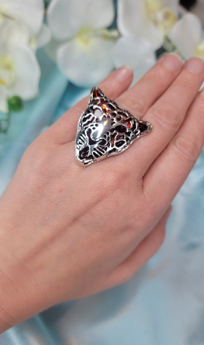 Precious Cheetah Baltic Amber .925 Sterling Silver handmade Large ring size 9 adjustable - Cheetah-shaped amber ring worn on hand with floral background.