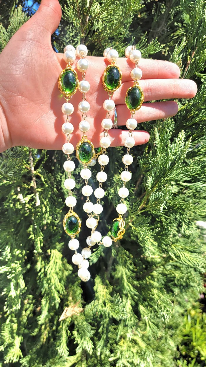 Incredible 48 inches long Freshwater Pearl 10K Gold over .925 Sterling Silver handmade Necklace - Pearl necklace with green gems held in hand against greenery.