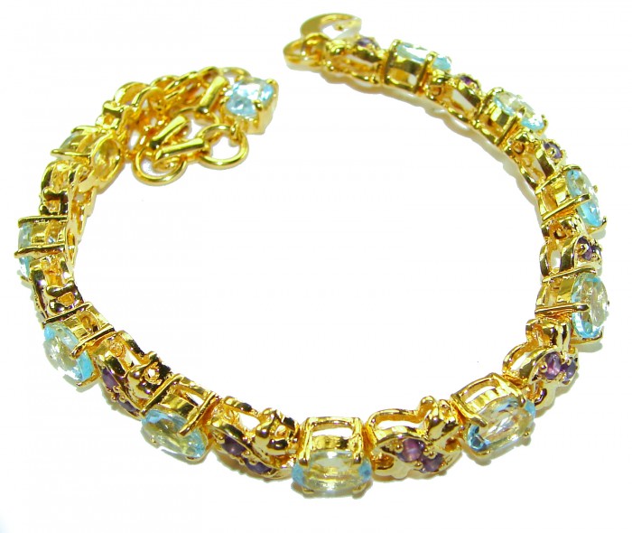 Genuine 24.5 carat Swiss Blue Topaz GARNET 14K Gold over .925 Sterling Silver handcrafted Bracelet - Gold bracelet with blue topaz and garnet, top view.