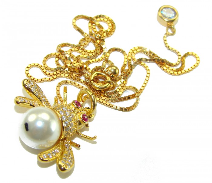 Precious Bees Genuine Pearl 14K Gold Gold over .925 Sterling Silver handcrafted handcrafted Necklace - Gold bee pendant with pearl, chain partially coiled, overhead view.