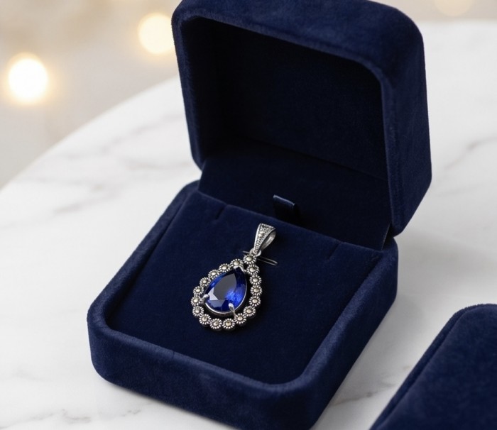 Julietta 14.5 carat London Blue Topaz Marcasite .925 Sterling Silver handmade Statement Pendant - Close-up of blue topaz pendant in a jewelry box.