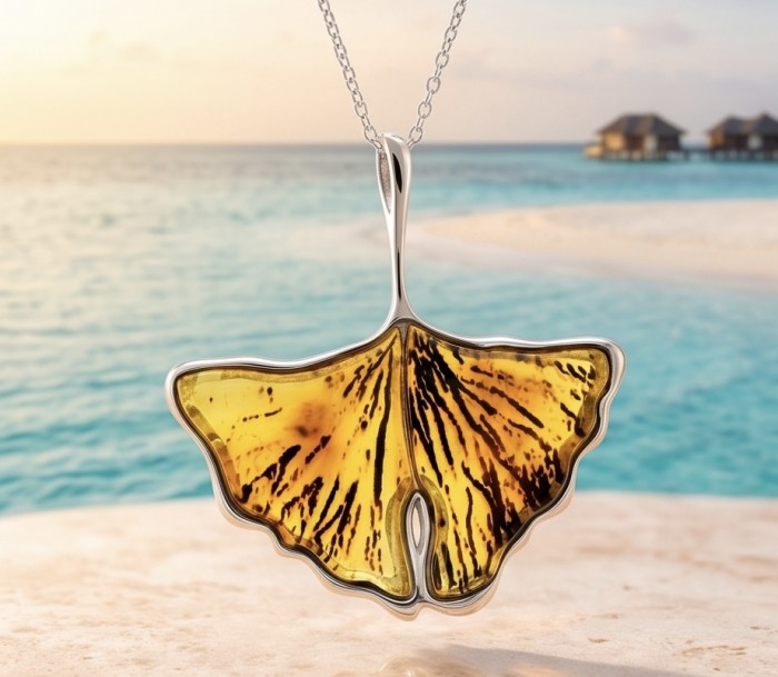 Calla Lily Prehistoric Authentic Butterscotch Baltic Amber .925 Sterling Silver beautifully handcrafted Pendant - Amber pendant front view with ocean backdrop.