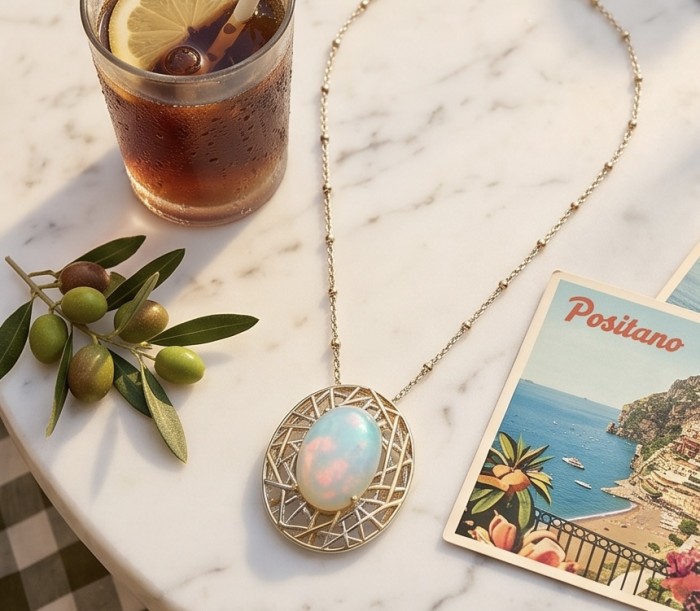 Earth Treasure Authentic 12.8 carat Golden Ethiopian Opal 22K Gold over .925 Sterling Silver handcrafted Statament Necklace - Golden Ethiopian Opal necklace on table with drink and Positano postcard