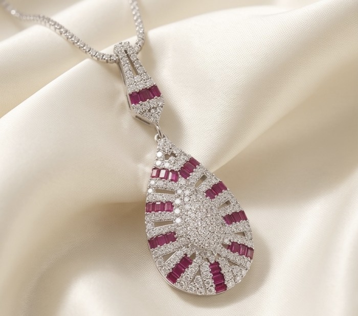 Art Deco - Izabella Luxurious natural 4.9 carat Ruby .925 Sterling Silver handmade necklace - Teardrop ruby and diamond pendant on cream fabric, frontal view.