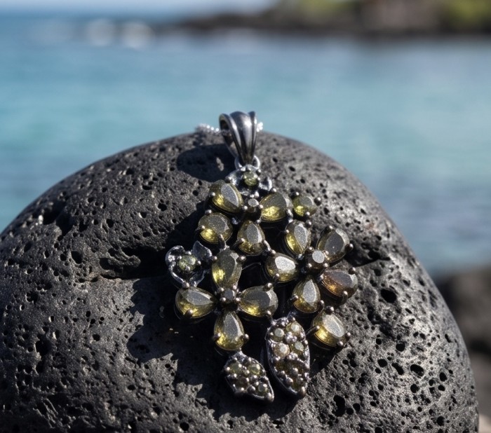Mystery Rare 12.5 carat Grandidierite black rhodium over .925 Sterling Silver Handcrafted pendant - Grandidierite pendant on lava rock, close-up shot.