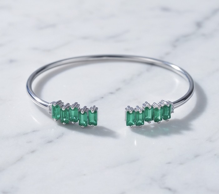 Art Deco 8.2 carat genuine Ruby .925 Sterling Silver handmade Statement Bracelet - Emerald and silver bracelet on marble surface, top view.