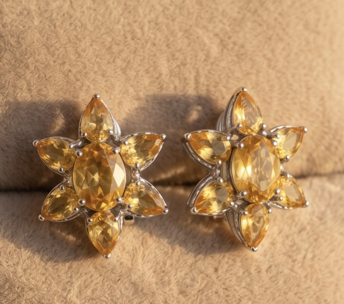 Giovanna - Authentic 18.9 carat Brazilian Citrine .925 Sterling Silver dipped in rhodium handcrafted earrings - Front view of citrine earrings on beige surface