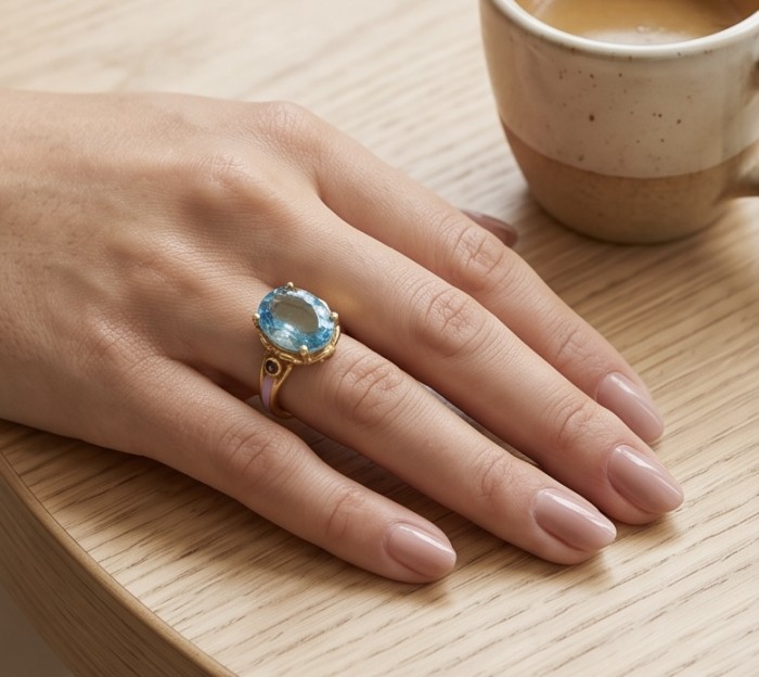 Conqueror Natural 34.8 carat Swiss Blue Topaz Enamel .925 Sterling Silver dipped in 22K Gold handmade Statement Ring size 8 - Blue topaz ring worn on hand, wooden table background.
