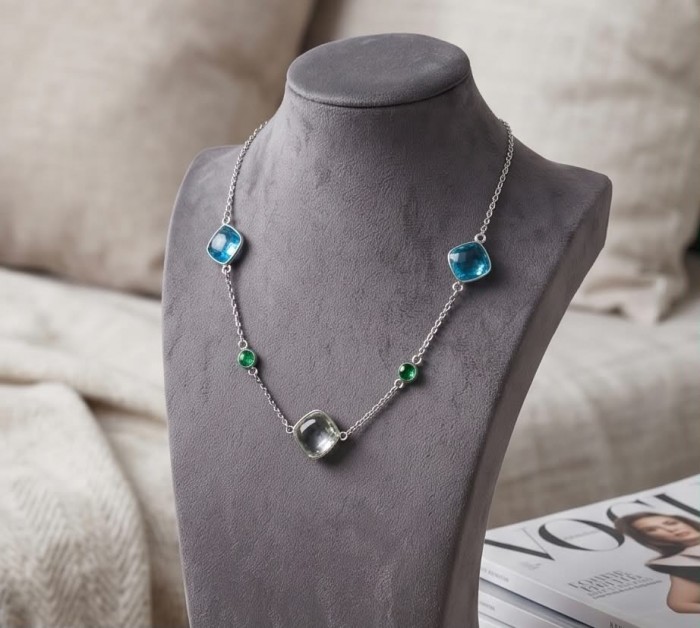 Infinity 18.5 carat Authentic Multigems Rhodium over .925 Sterling Silver handcrafted Statement necklace - Side view of Infinity necklace with multigems on a display stand.