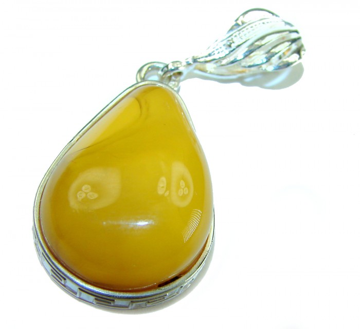Prehistoric Authentic Buttescotch Baltic Amber .925 Sterling Silver beautifully handcrafted Pendant - Close-up of butterscotch amber pendant with silver setting.