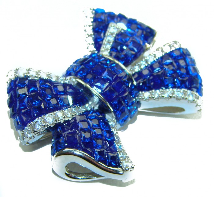Heirloom blue Bow Genuine 17.5 carat Sapphire .925 Sterling Silver handmade Pendant - Close-up of blue sapphire bow brooch with sterling silver accents.