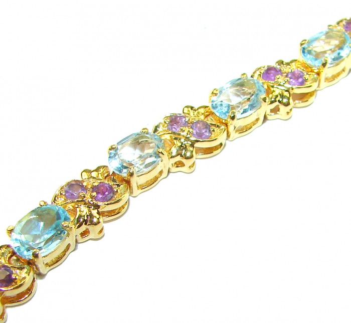 Genuine 24.5 carat Swiss Blue Topaz GARNET 14K Gold over .925 Sterling Silver handcrafted Bracelet - Gold bracelet with blue topaz and garnet, side view.