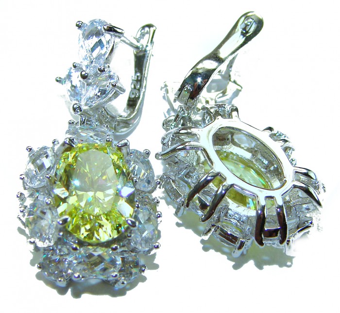 Luxurious 10.5 carat Golden - yellow Montana Sapphire .925 Sterling Silver handcrafted earrings - Close-up of golden-yellow sapphire earrings with .925 silver setting.