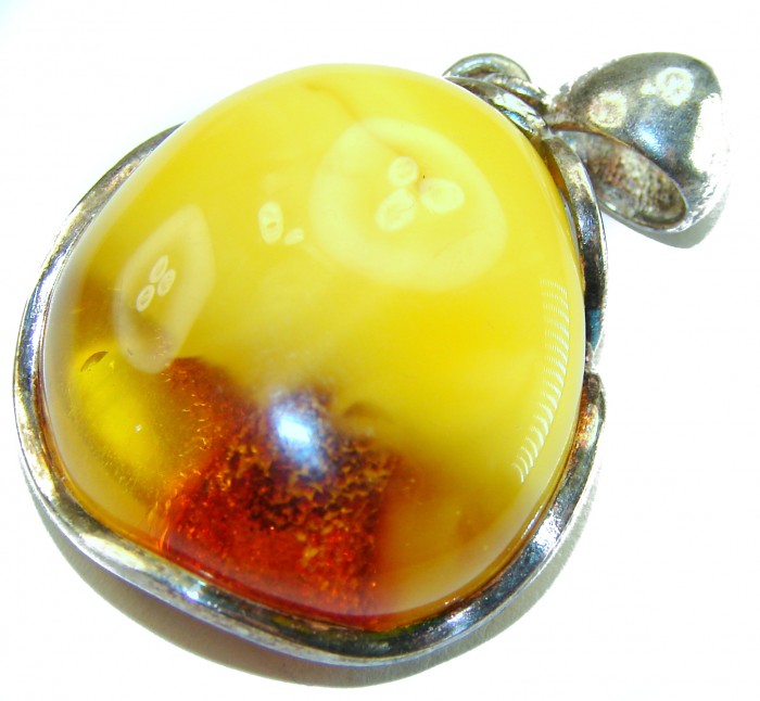 Sea Treasure Prehistoric Authentic Butterscotch Baltic Amber .925 Sterling Silver beautifully handcrafted Pendant - Close-up of Baltic amber pendant with silver setting.