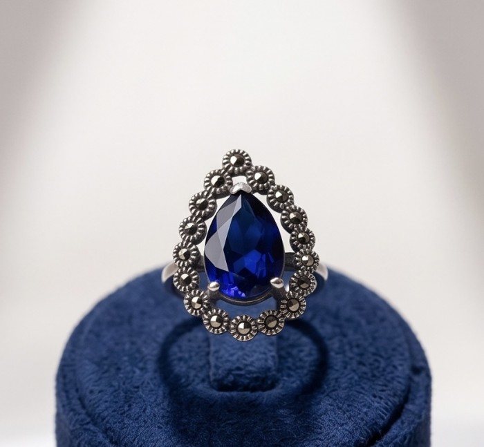 Julietta 12.8 carat London Blue Topaz Marcasite .925 Sterling Silver handmade Statement Ring size 7 1/4 - Julietta blue topaz ring, front view on a blue display stand.