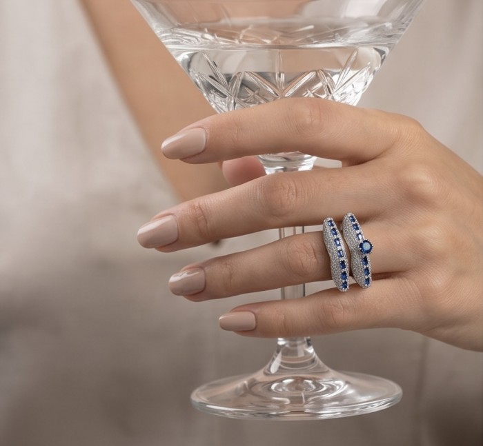 Extravaganza Large 5.6 carat Sapphire .925 Sterling Silver brilliantly handcrafted stack up ring s. 7 - Sapphire silver ring worn on hand holding a crystal glass.