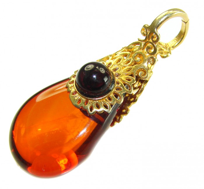 Prehistoric Authentic Baltic Amber 18K Gold over .925 Sterling Silver beautifully handcrafted Pendant - Close-up of Baltic amber pendant with gold filigree and black stone.