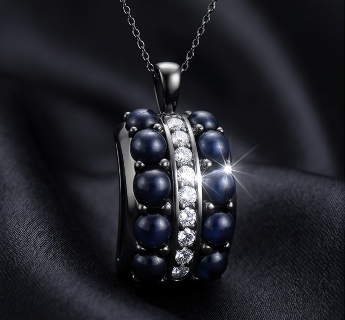 Born to Glam 7.2 carat natural Sapphire black rhodium over .925 Sterling Silver Perfectly handcrafted Pendant - Close-up of Born to Glam 7.2 carat Sapphire pendant on black fabric.