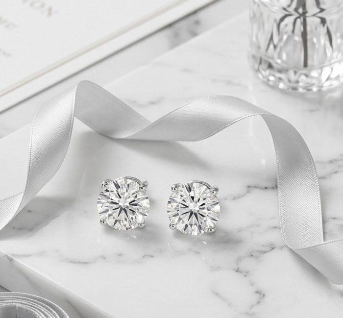 Angelina 8.9 carat authentic White Topaz .925 Sterling Silver Handcrafted Earrings - Topaz earrings on marble with ribbon, close-up view
