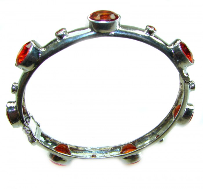 Red Galaxy Spectacular 25.2 carat authentic Ruby .925 Sterling Silver handmade bangle Bracelet - Aerial view of silver bracelet with red gemstones.