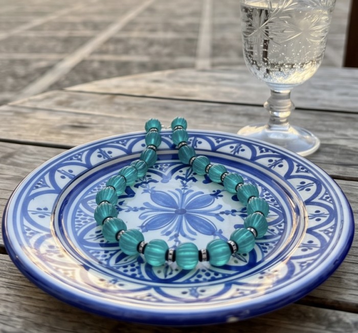 Art Deco - Rio de Janeiro - 52.2 carat carved Apatite .925 Sterling Silver handmade necklace - Blue apatite necklace on decorative plate with beverage in background