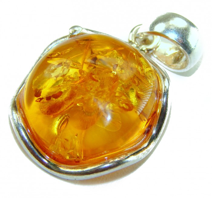 Prehistoric cognac Authentic Baltic Amber .925 Sterling Silver beautifully handcrafted Pendant - Close-up of cognac Baltic amber pendant in silver setting.
