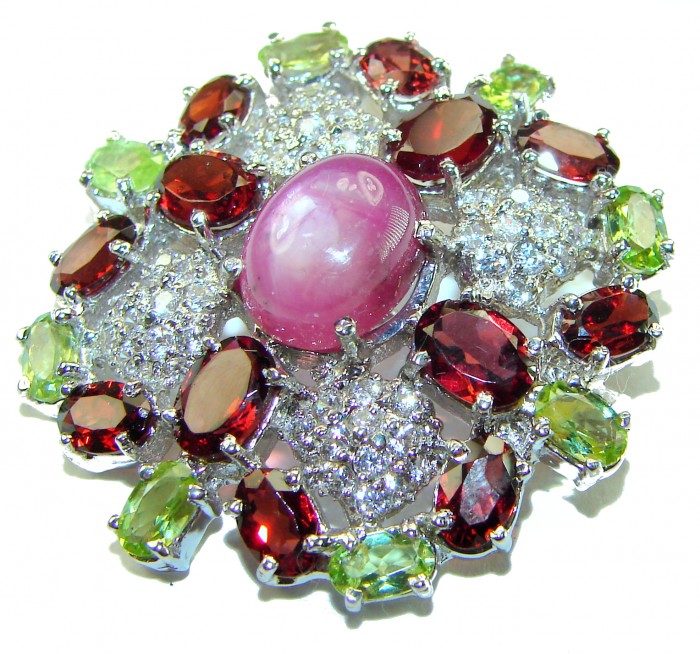 Excellent quality 5.2 carat Genuine Star Ruby .925 Sterling Silver handmade Pendant - Brooch - Close-up of star ruby jewelry with multicolored gemstones.