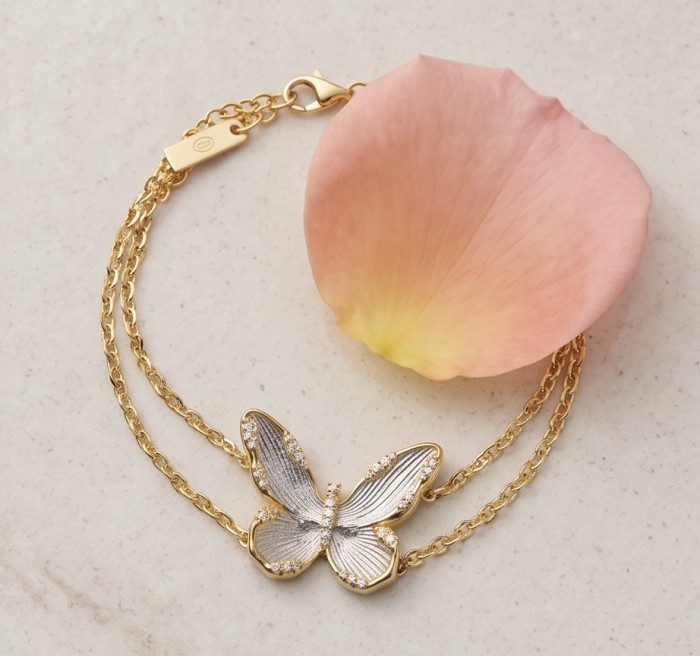 Golden Butterfly White Topaz highly polished 18K Gold over .925 Sterling Silver Italy made bracelet - Golden butterfly bracelet with topaz, side view, on pink petal background