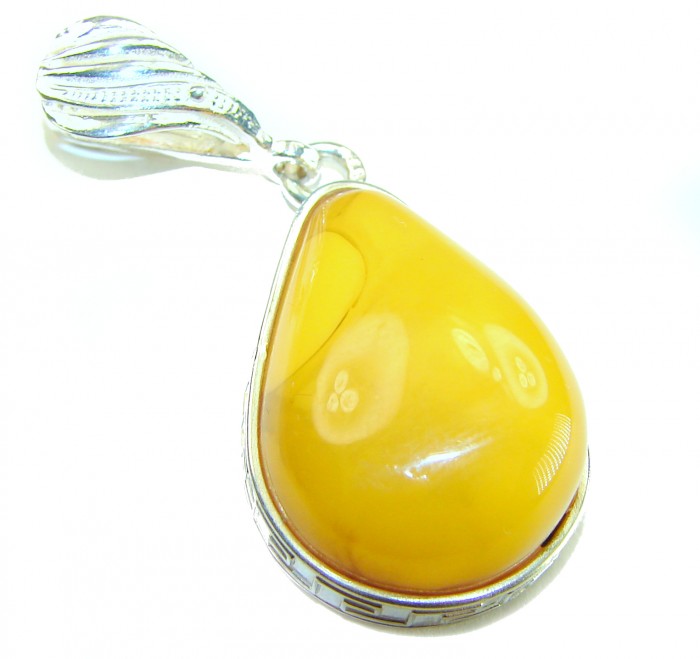Prehistoric Authentic Buttescotch Baltic Amber .925 Sterling Silver beautifully handcrafted Pendant - Close-up of a butterscotch Baltic amber pendant with sterling silver.