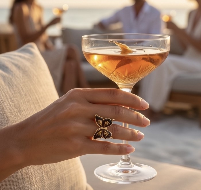 Butterfly Authentic Baltic Amber .925 Sterling Silver dipped in 18K Gold handcrafted ring; s. 7 adjustable - Butterfly Amber Silver Ring worn on hand holding a cocktail glass.