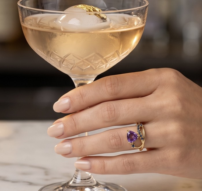 Purple Queen trillion cut 5.2 carat Amethyst 18K Gold over .925 Sterling Silver Handcrafted Ring size 8 - Amethyst ring on hand holding a cocktail glass with gold leaf ice.