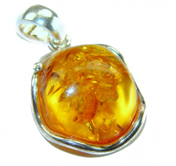 Prehistoric cognac Authentic Baltic Amber .925 Sterling Silver beautifully handcrafted Pendant - Amber pendant close-up with silver setting detail.