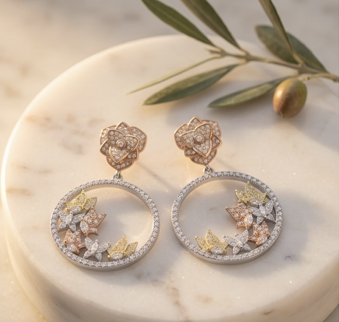 Black Label Collection - Floral design - Natural White Topaz 22K Gold over .925 Sterling Silver handmade 3 tones earrings - Floral topaz earrings on a marble surface, elegant flat lay.