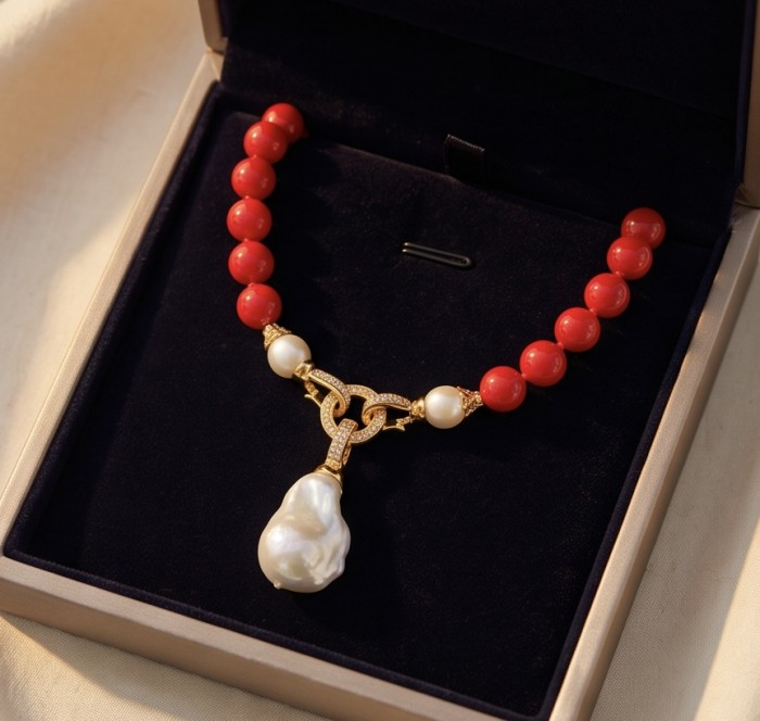 Konstancia Sublime natural Red Fossilized Coral 14K Gold over Sterling Silver handmade Necklace - Necklace in box, top view showing coral beads and pearl pendant.