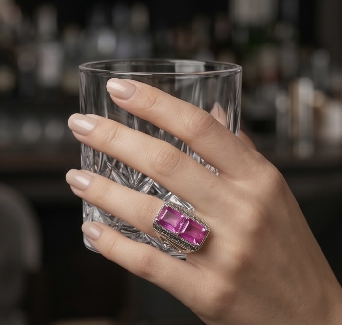 Anastasia 18.2 carat Pink Sapphire .925 Sterling Silver dipped in Rhodium Handcrafted Statement Ring size 8 - Pink Sapphire ring in sterling silver, worn on hand holding a glass.