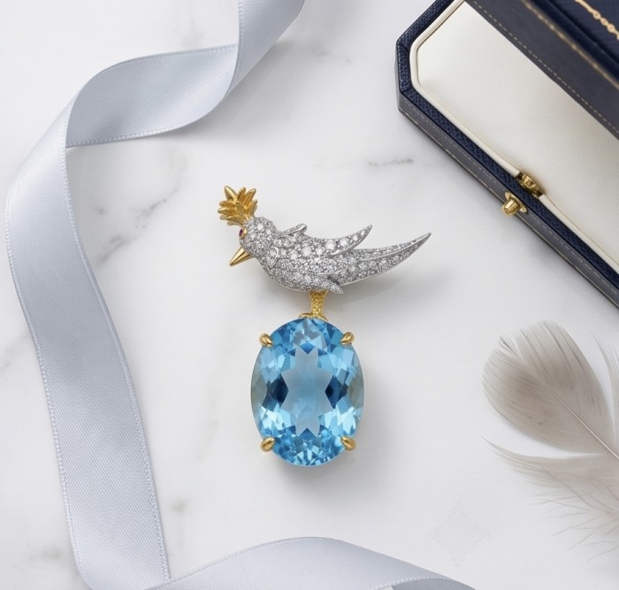 Bird on a Rock - Iconic design- Genuine 28.5 carat Aquamarine 18K Gold over .925 Sterling Silver handmade Pendant - Brooch - Bird on a Rock brooch with aquamarine, top view on marble background.