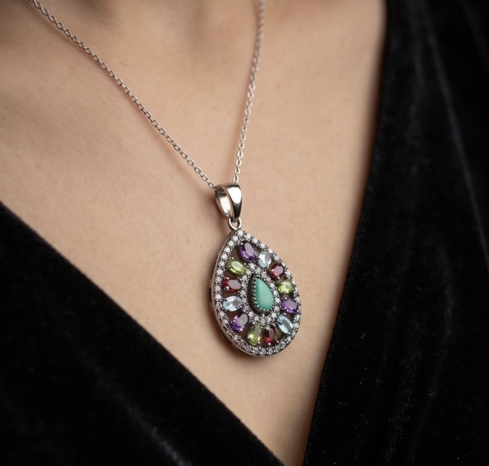 Victorian style - 14.5 carat Authentic Emerald .925 Sterling Silver dipped in black rhodium handcrafted Pendant - Close-up of Victorian-style emerald pendant necklace being worn