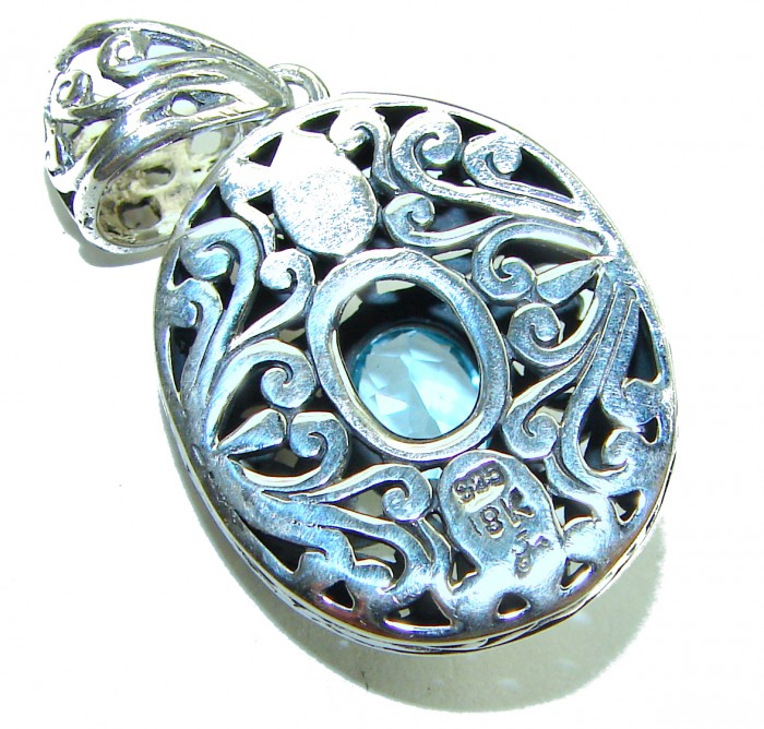 Atlantica oval cut 5.9 carat Swiss Blue Topaz 14K Gold over .925 Sterling Silver Handcrafted Pendant - Close-up of Atlantica pendant with blue topaz and ornate silver design.