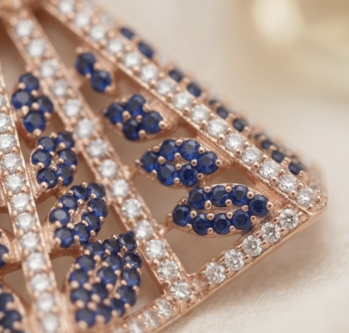 Luxurious 5.2 carat Sapphire .925 Sterling Silver dipped in 18K Rose Gold handmade Pendant - Close-up of sapphire and diamond details on silver jewelry piece.