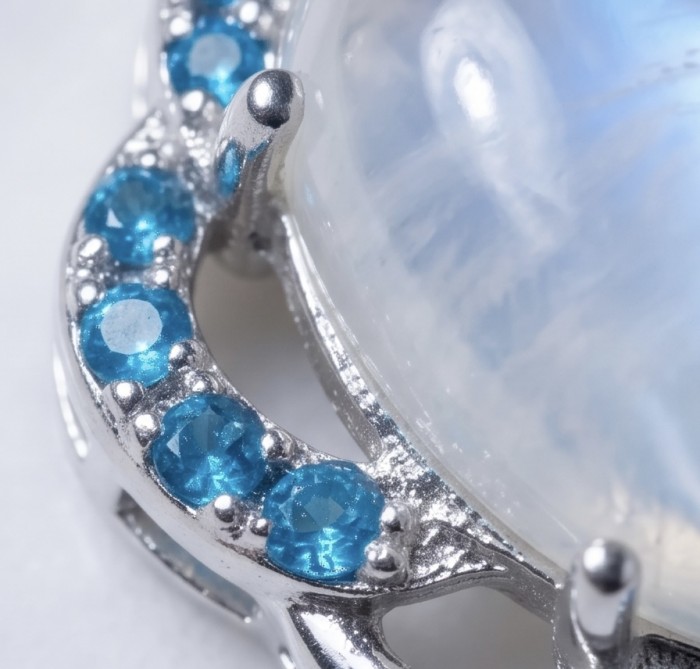 Genuine 7.2 carat Fire Moonstone .925 Sterling Silver handcrafted pendant - Close-up of Fire Moonstone set in .925 Sterling Silver with blue accents.