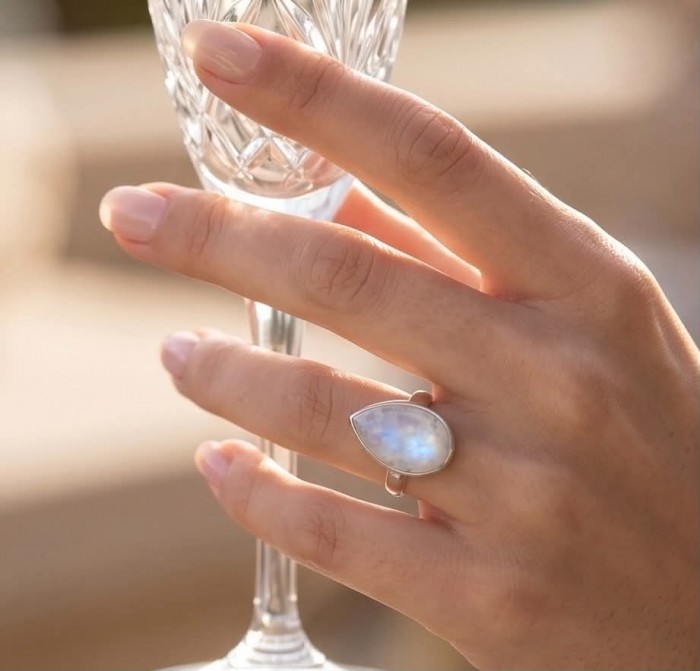Rainbow Moonstone .925 Sterling Silver handmade ring s. 7 1/2 - Rainbow Moonstone ring worn on hand, holding a glass.