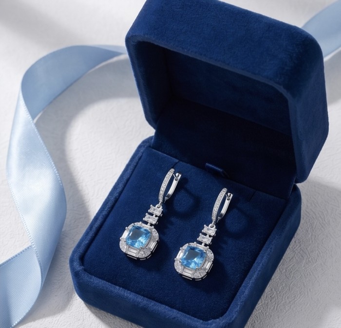 Atlantica 14.7 carat princess cut Swiss Blue Topaz rhodium over .925 Sterling Silver Handcrafted Statement earrings - Earrings in blue velvet box, top view showing Swiss Blue Topaz stones.
