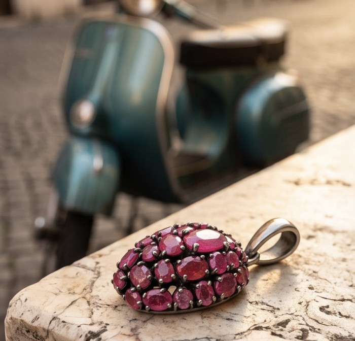 Giovanna 27.2 carat authentic Mozambique Ruby black rhodium .925 Sterling Silver handmade Pendant - Ruby pendant close-up with background of a vintage blue scooter