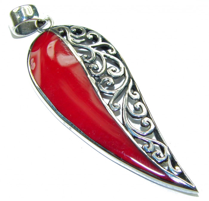 Real Coral .925 Sterling Silver Pendant - Red coral and silver pendant, side view showing detailed swirl design.