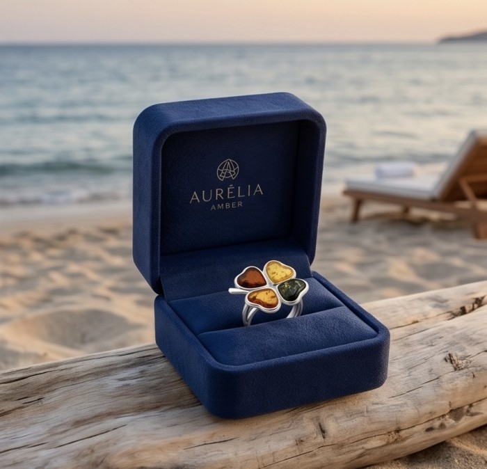 Golden Flower Authentic Baltic Amber rhodium over .925 Sterling Silver handcrafted ring; s. 7 adjustable - Golden Flower Baltic Amber ring in box, beach background, front view.