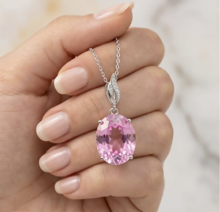 Tiffany - authentic 14.5 carat Pink Topaz .925 Sterling Silver handcrafted Statement pendant - Pink Topaz pendant in hand, showing stone and chain detail.