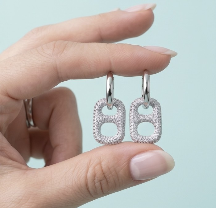 Precious Memories 2.5 carat pave White Topaz .925 Sterling Silver Handcrafted Statement earrings - Close-up of earrings with pave White Topaz held between fingers