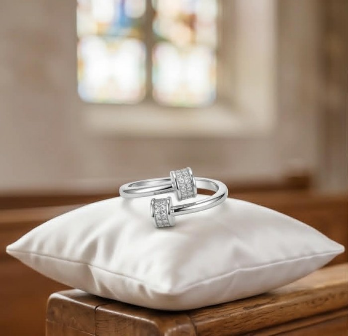 Luxurious pave 1.5 carat White Topaz .925 Sterling Silver Solid Infinity ring size 7 - White Topaz rings on pillow in church setting, focus on design detail.