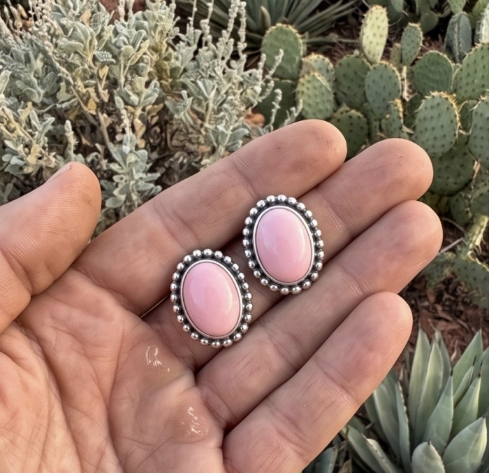 4.2 carat Pink Opal .925 Sterling Silver incredible handcrafted Earrings - Pink Opal earrings in hand, close-up with cactus background.