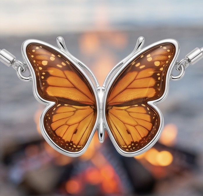 Golden Butterfly Genuine carved Baltic Amber rhodium over .925 Sterling Silver handamde Bracelet - Close-up of butterfly-shaped amber pendant with fire background.